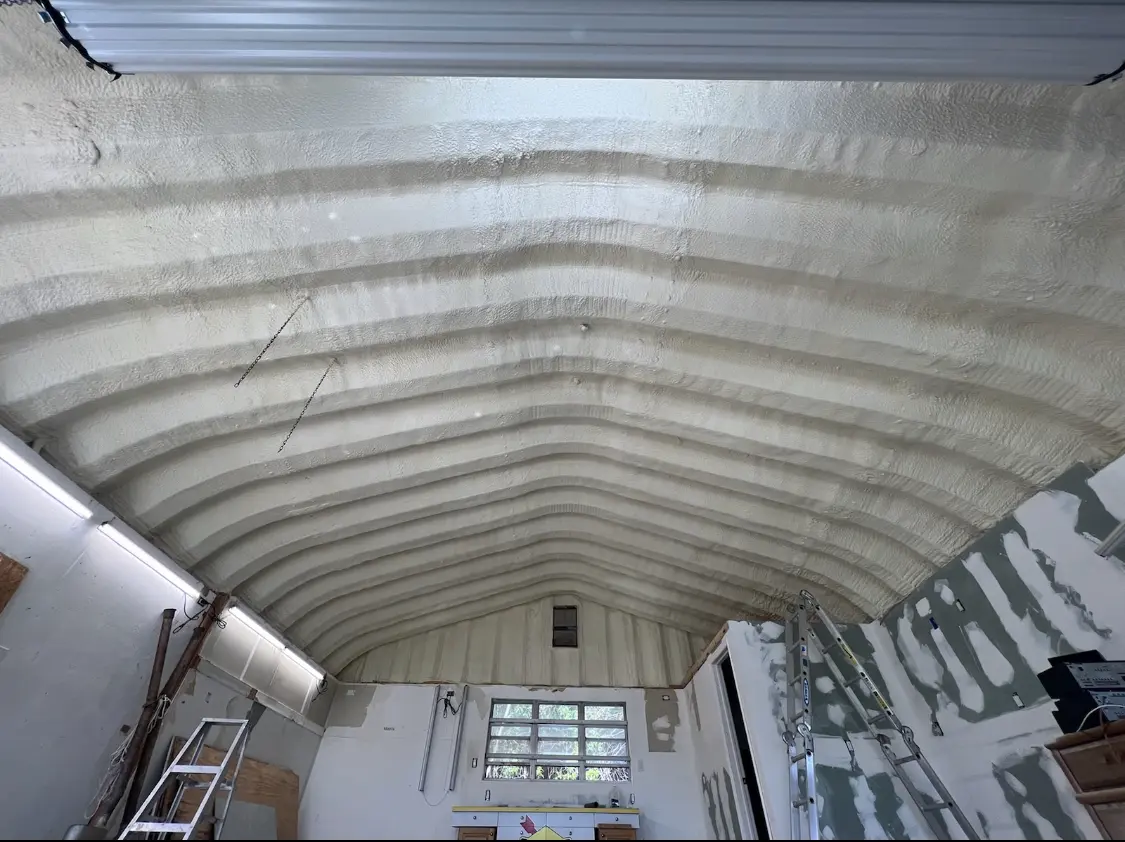 Spray polyurethane foam applied to the underside of a metal roof deck in West Lafayette